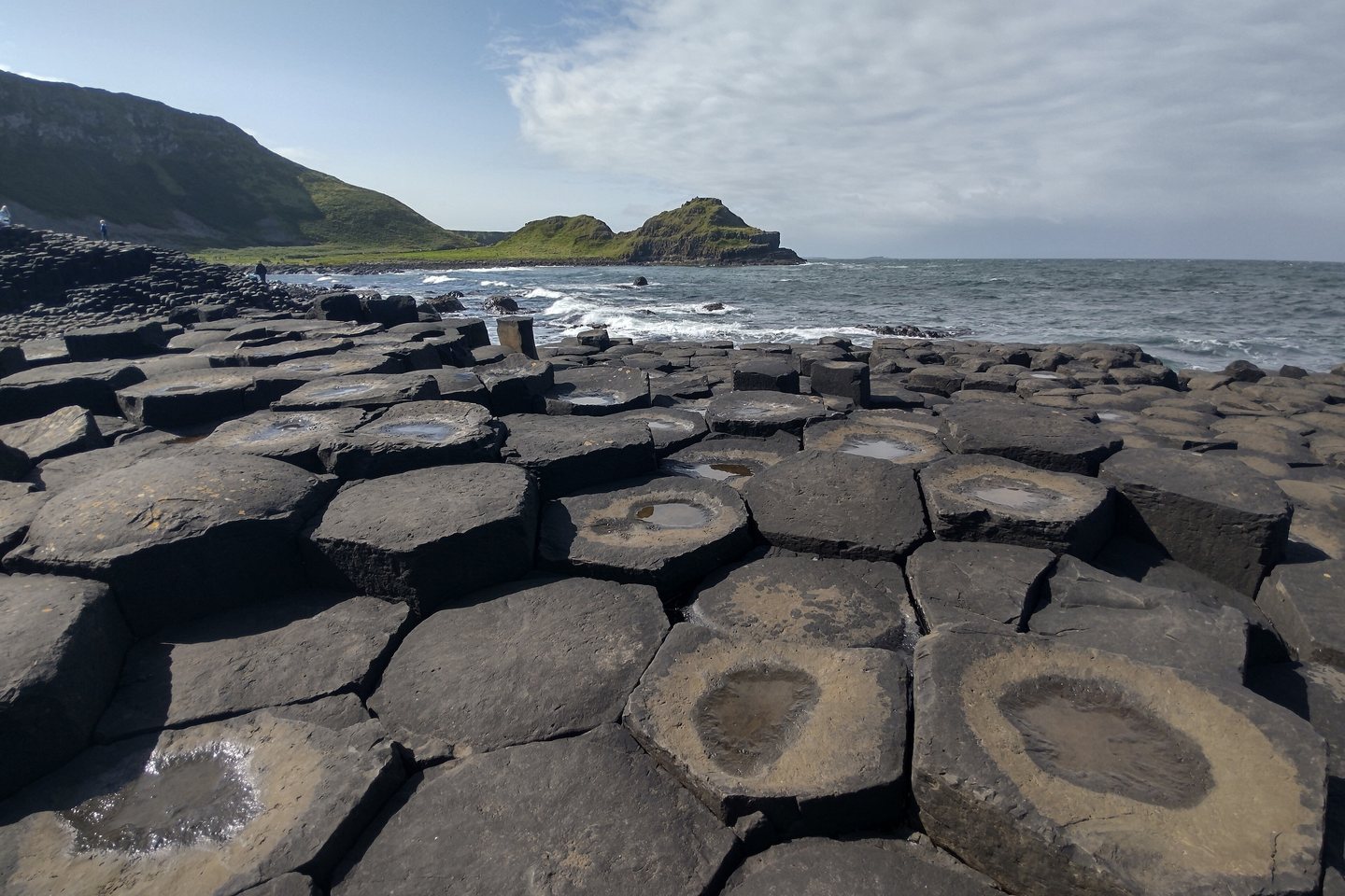 The basalt columns of the Giant&rsquo;s Causeway stepping down into the sea.