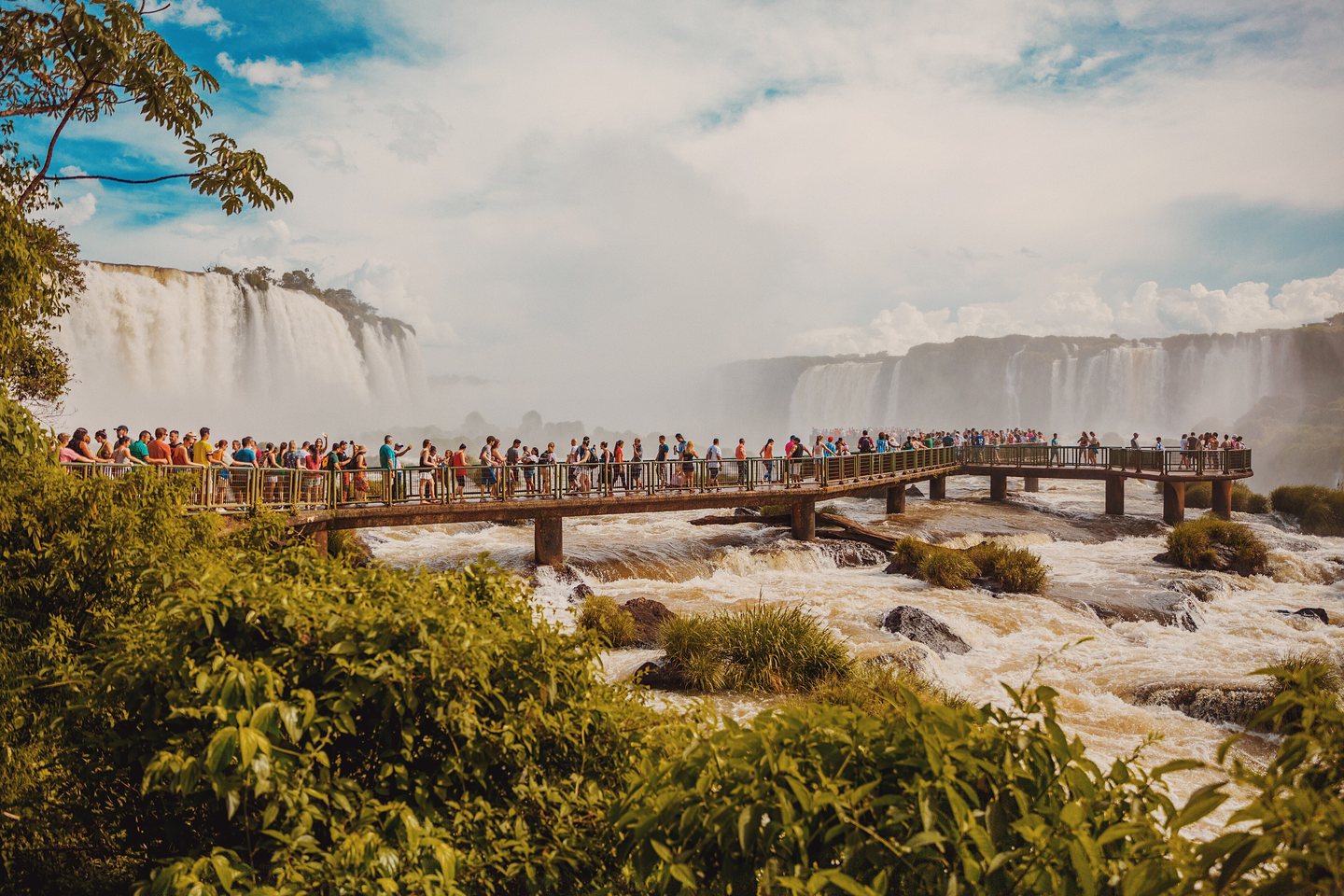 Waterfalls of the Iguazu river dropping through dense green forest.
