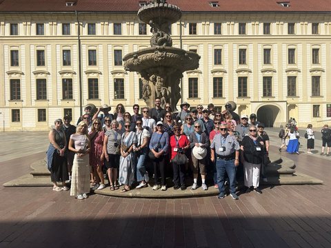 The full MyTribe group posed together in front of a baroque palace fountain in Vienna.